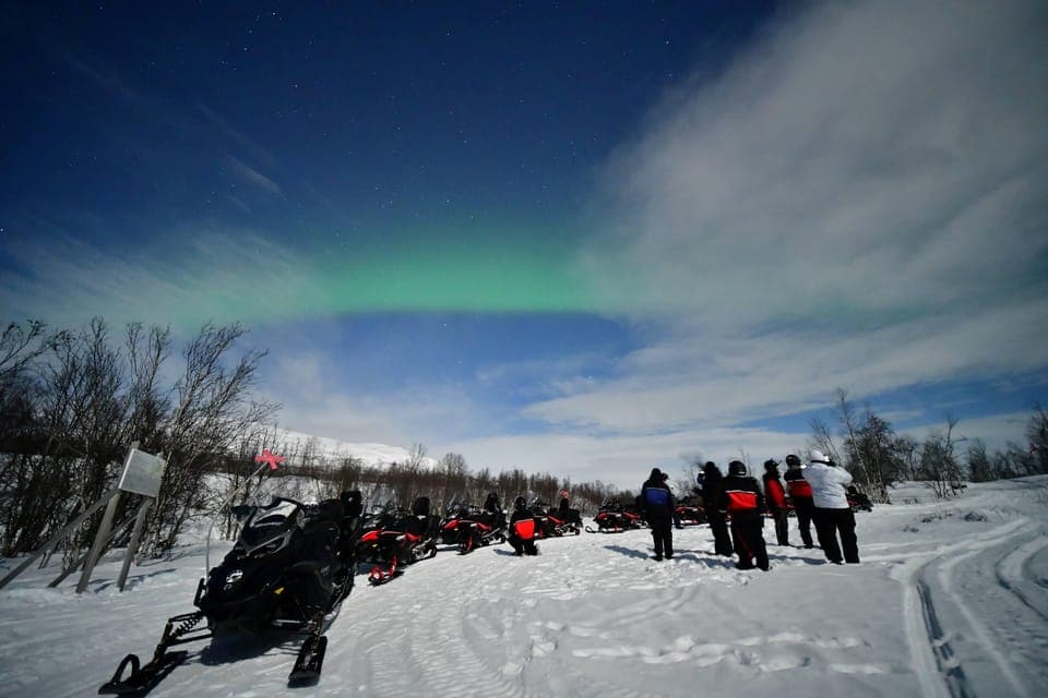 Aurora chasing by snowmobile